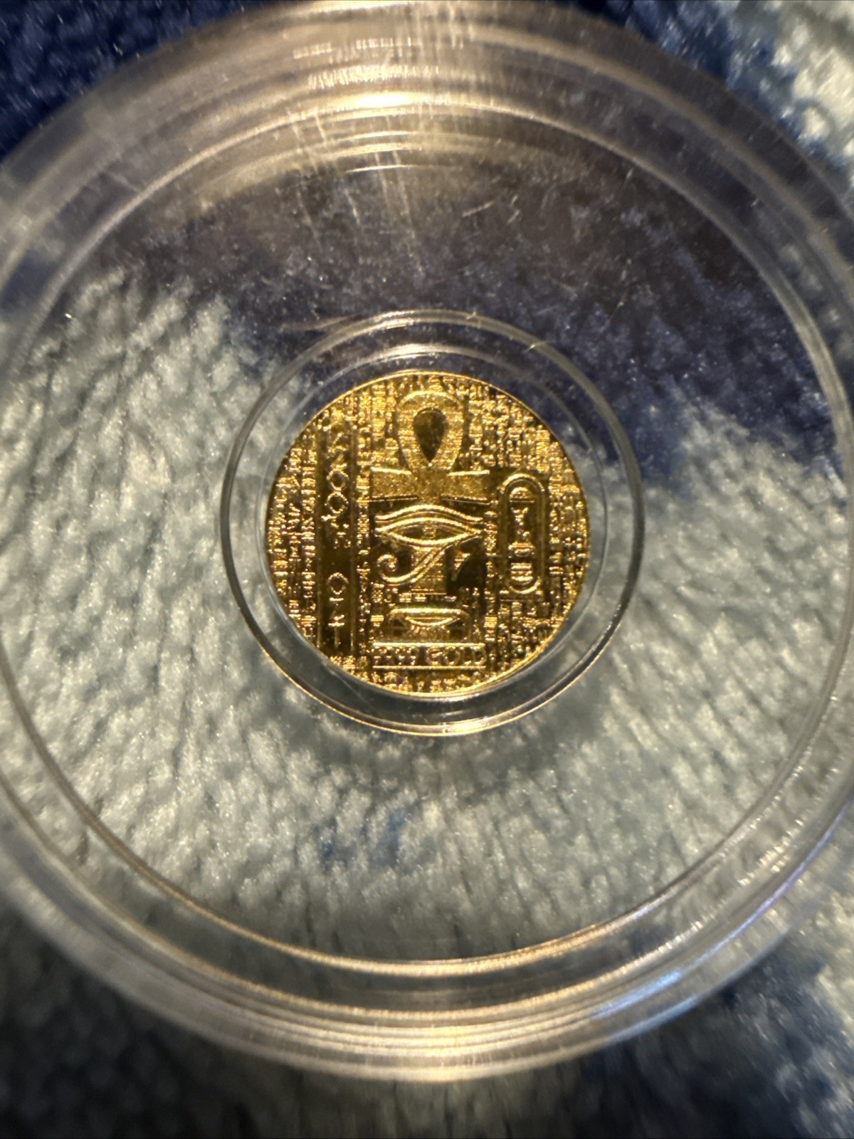 1/200th Gold monarch Egyptian Eye of Ra/reverse depicts scarab. in capsule
