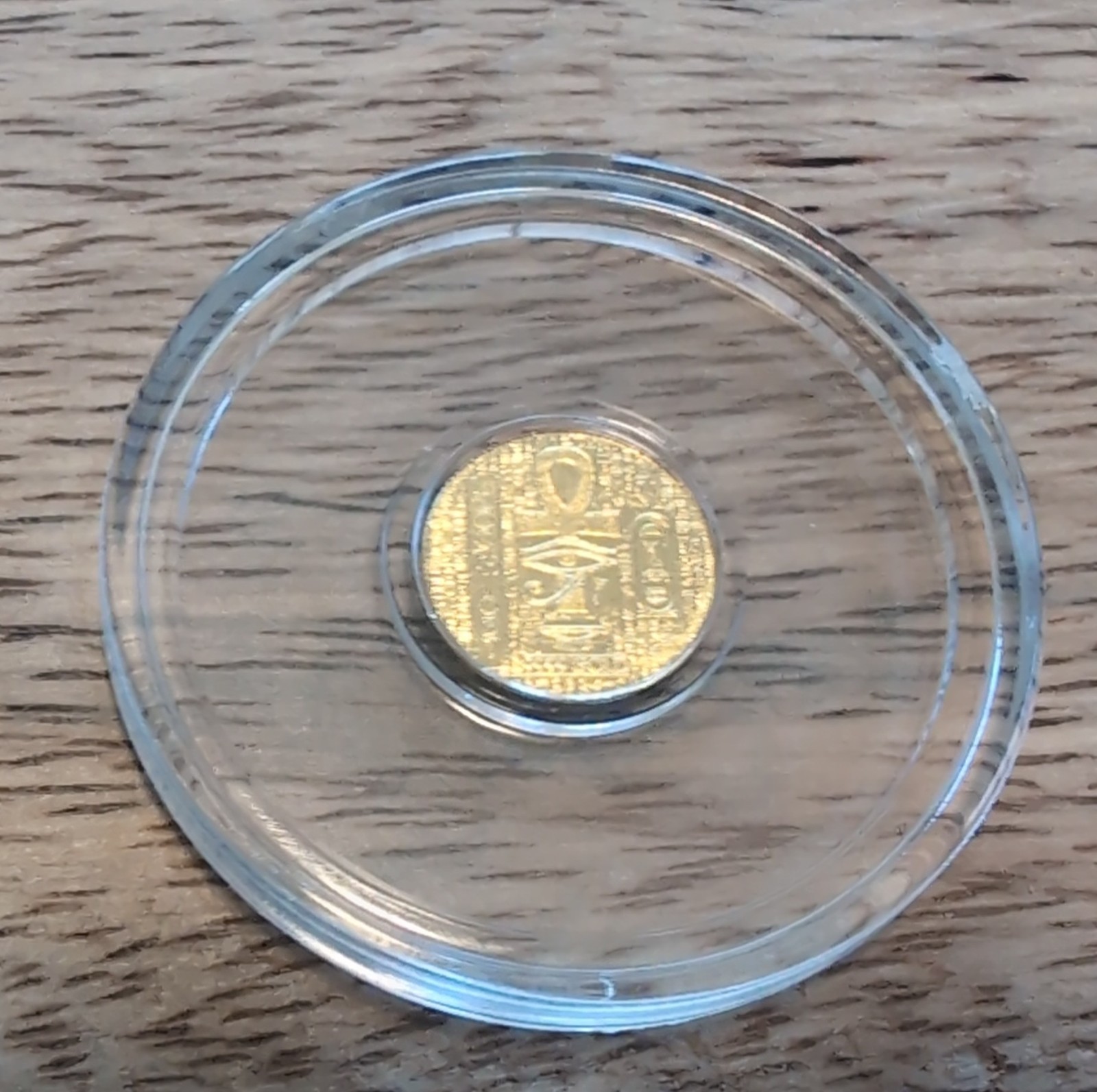 1/200th Gold monarch Egyptian Eye of Ra/reverse depicts scarab. in capsule