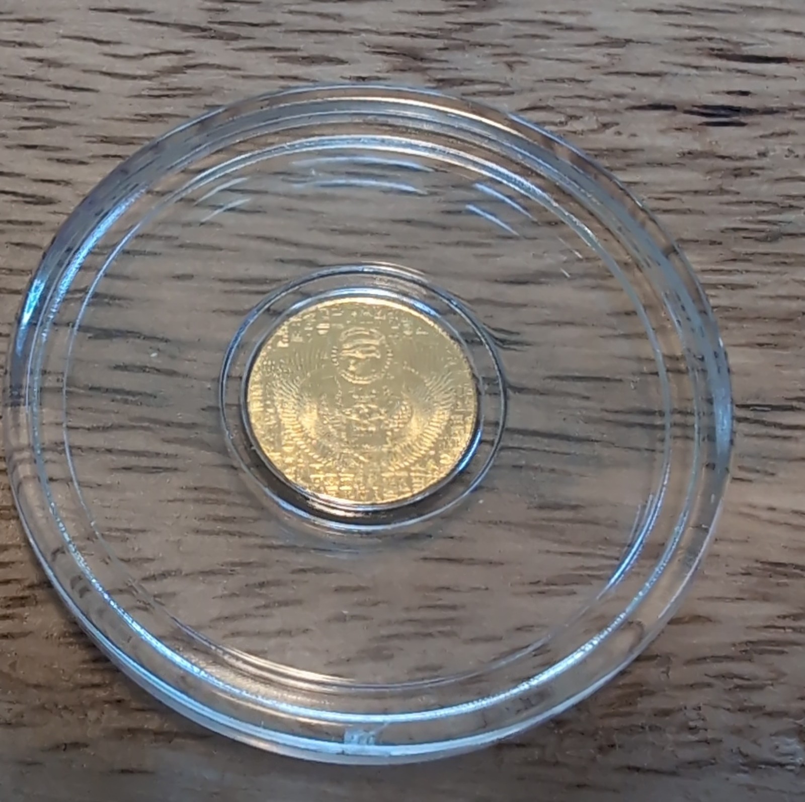 1/200th Gold monarch Egyptian Eye of Ra/reverse depicts scarab. in capsule