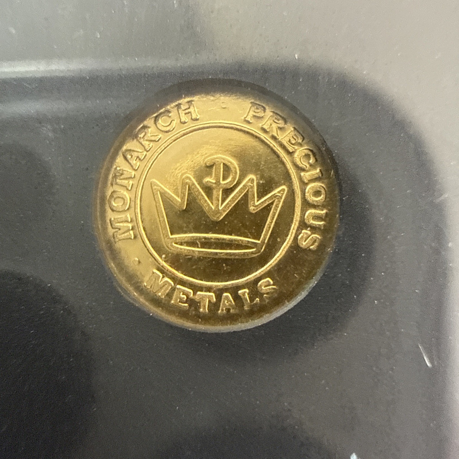 A 1/100 OZ MONARCH .9999 FINE GOLD EAGLE ROUND IN CAPSULE