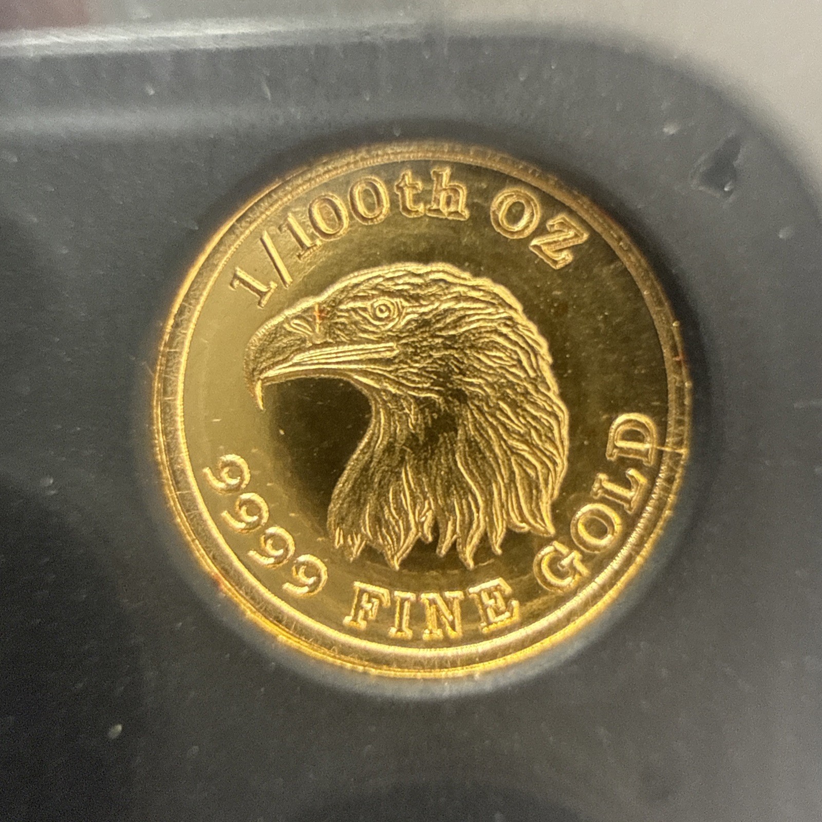 A 1/100 OZ MONARCH .9999 FINE GOLD EAGLE ROUND IN CAPSULE