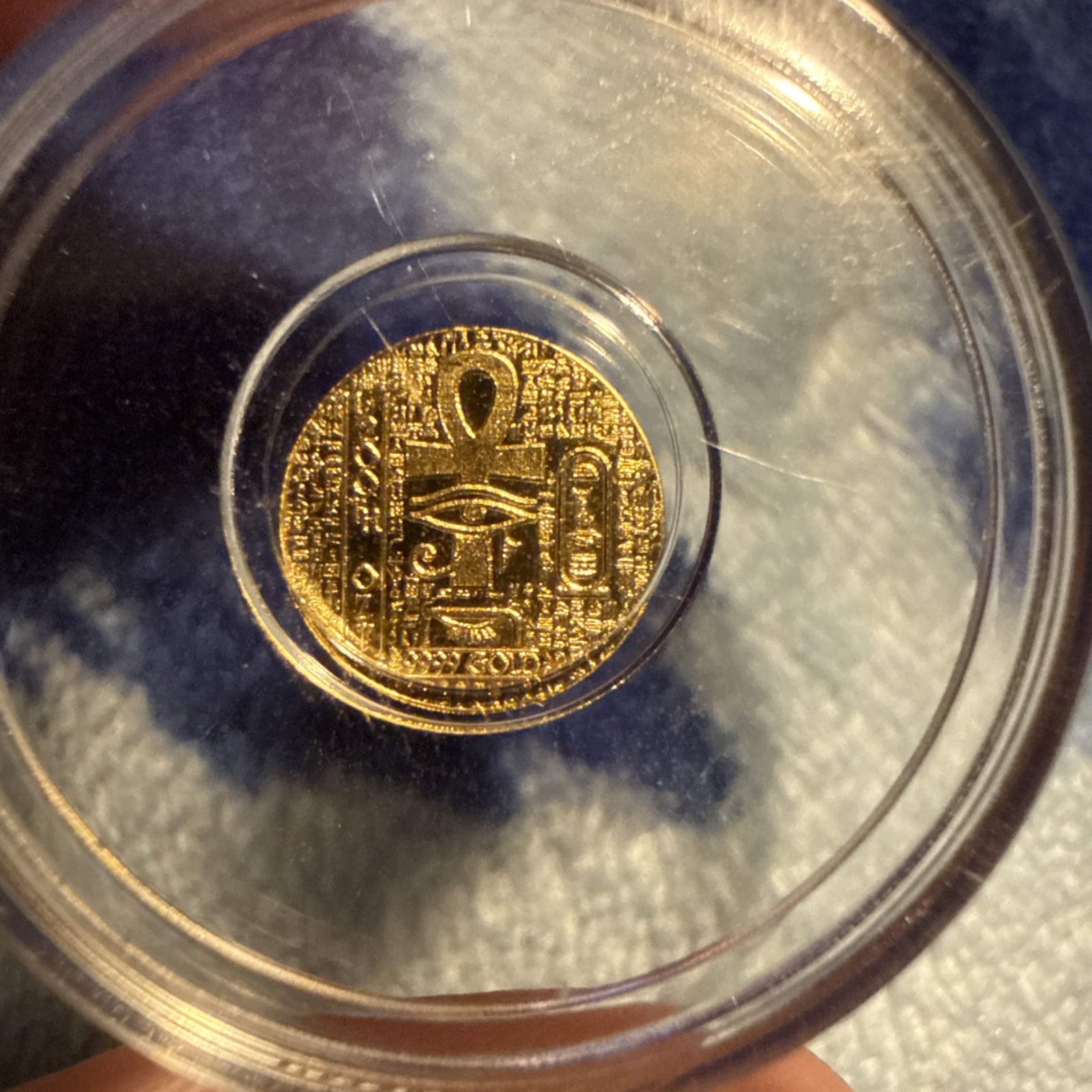 1/200th Gold monarch Egyptian Eye of Ra/reverse depicts scarab. in capsule