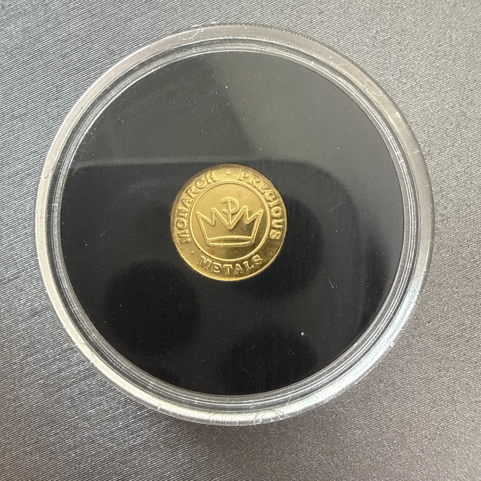 A 1/100 OZ MONARCH .9999 FINE GOLD EAGLE ROUND IN CAPSULE