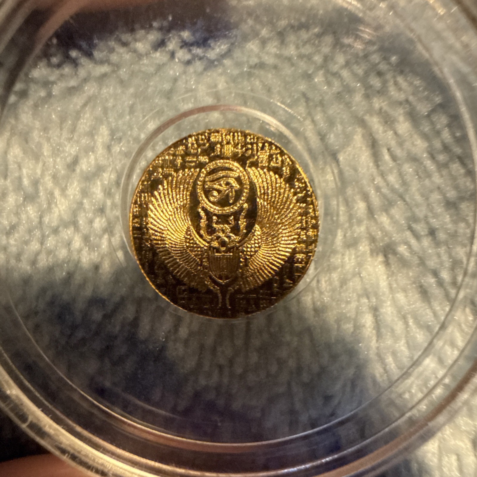 1/200th Gold monarch Egyptian Eye of Ra/reverse depicts scarab. in capsule